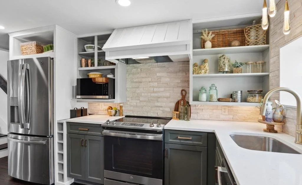 Finished kitchen with gray shaker cabinets, white quartz counters, open shelving and pendant lighting.