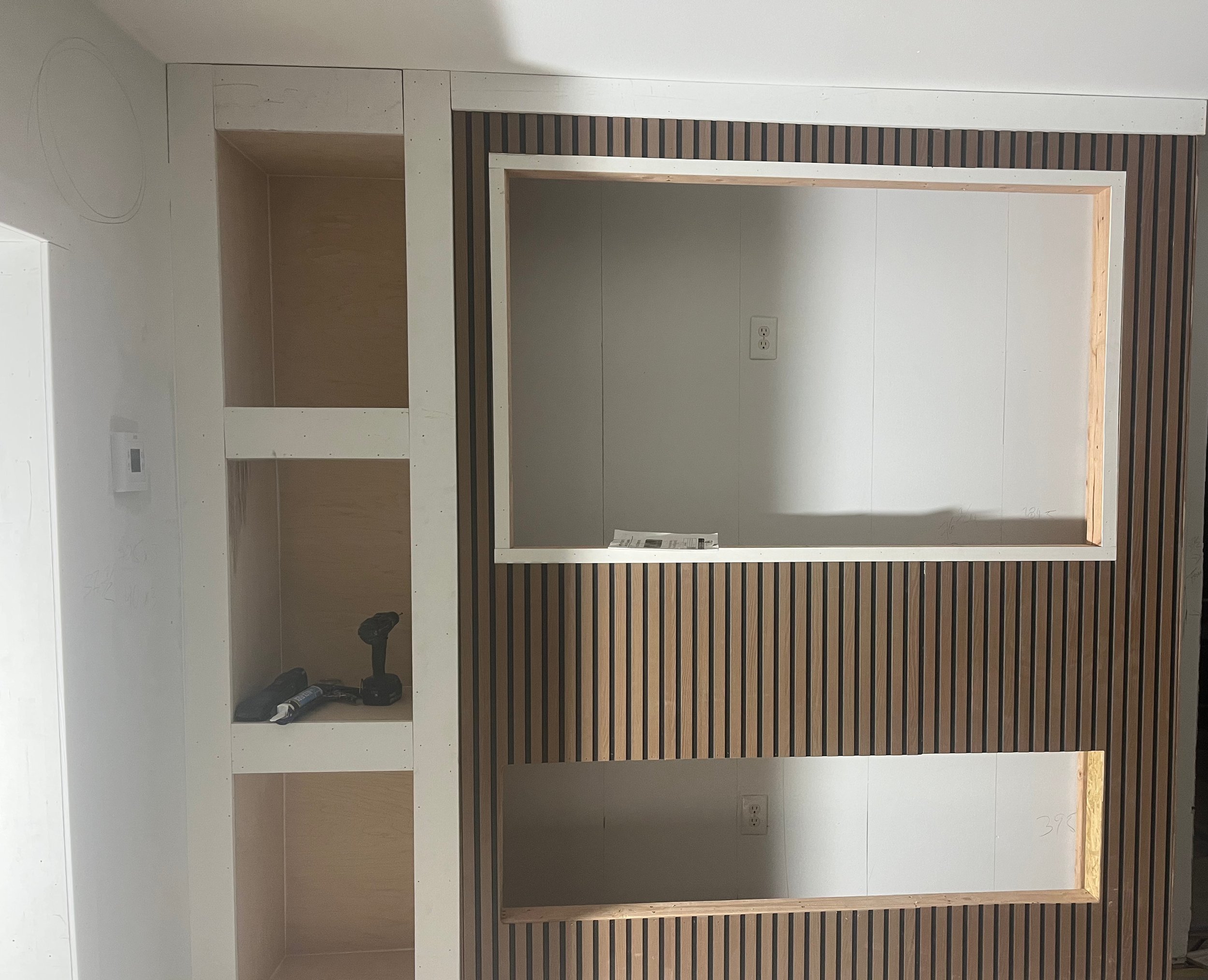 Custom built-in, framed and finished to fit the space exactly with useful storage and a clean look.