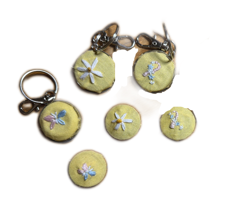 1.2" Keychains and 1" Pins with Featured PAIL Flash Designs: PAIL Ribbon, Butterfly, and Daisy