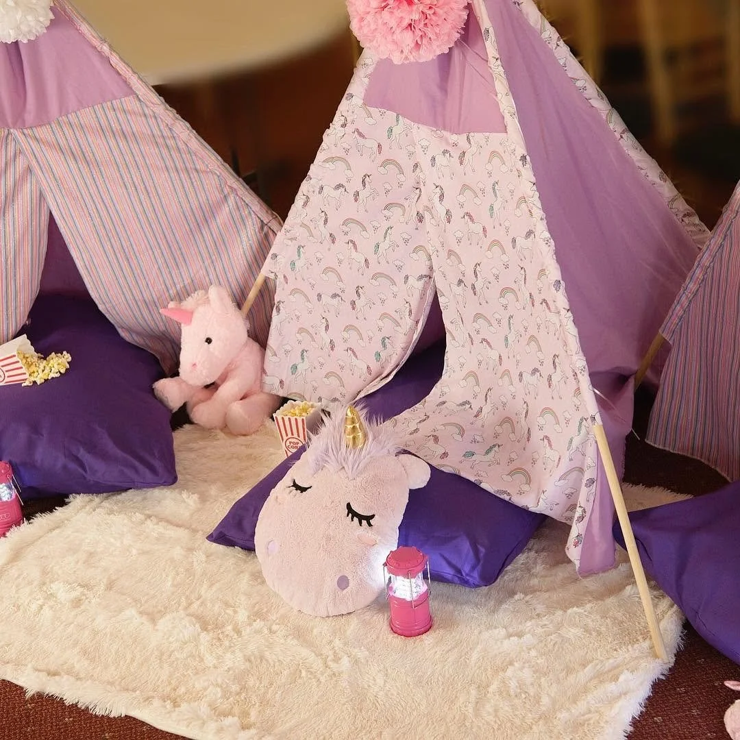 Unicorn themed teepee tent set up for an indoor glamping celebration