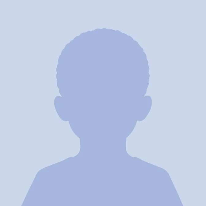 Silhouette of a young boy with short hair against a light blue background.