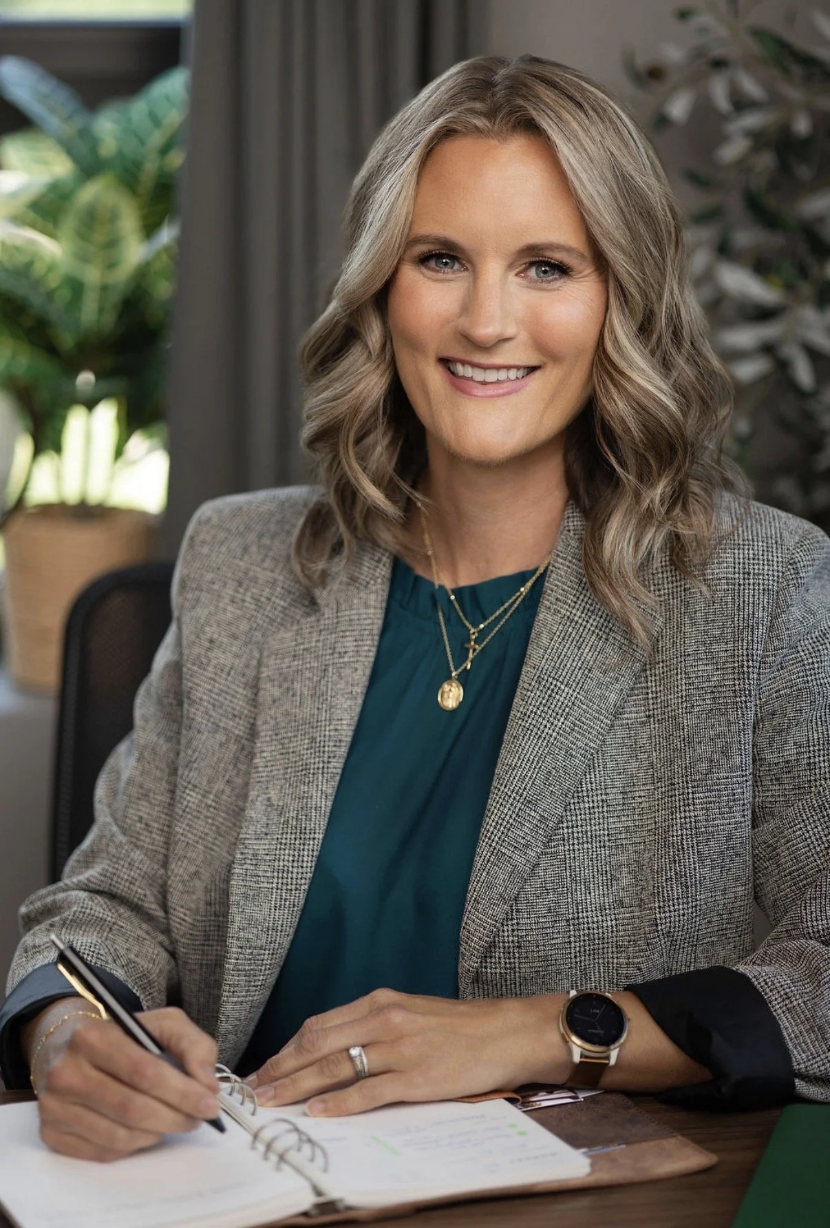 smiling professional woman writing an agenda in a calendar to get clarity