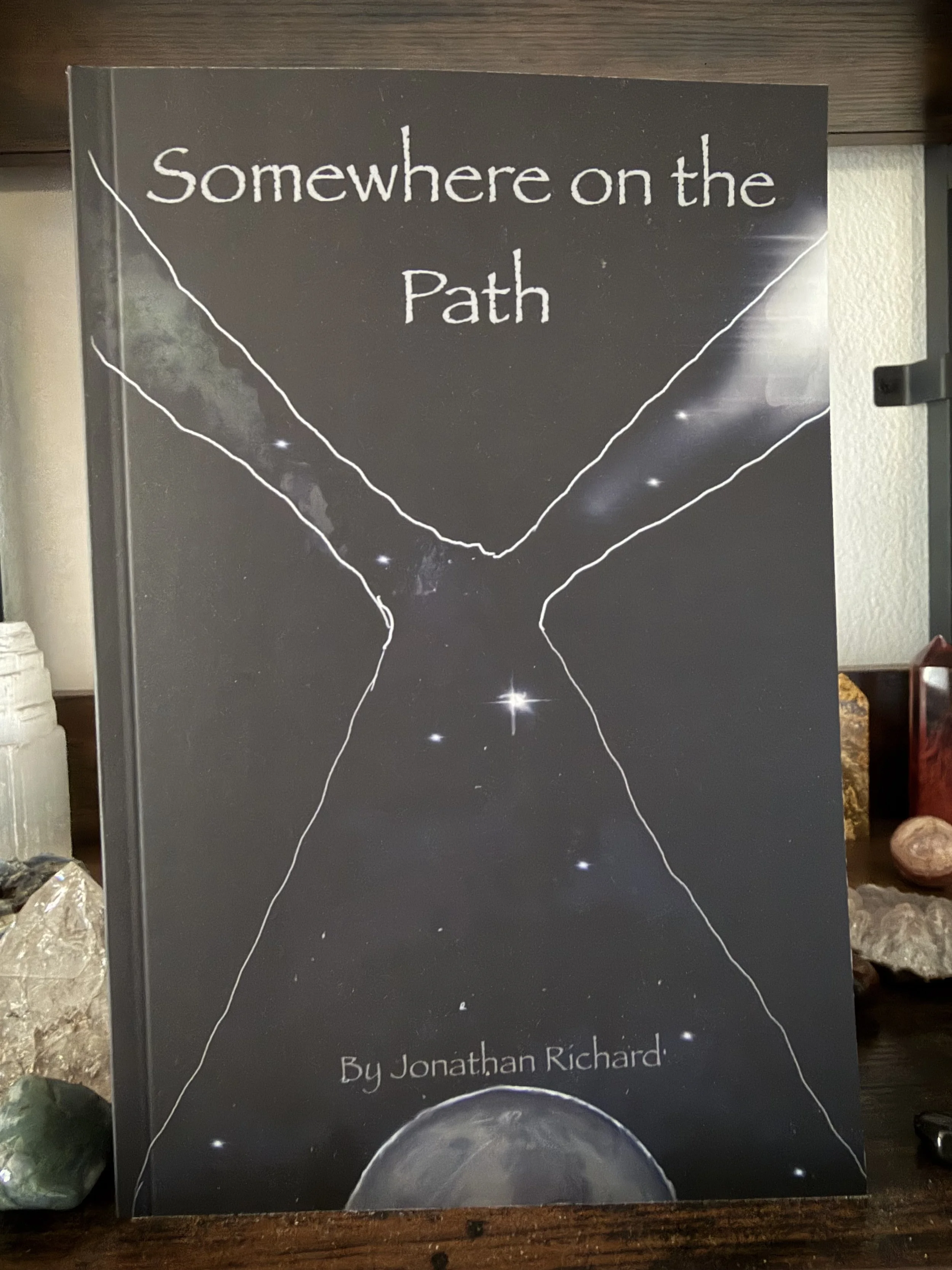Book titled "Somewhere on the Path" by Jonathan Richard, featuring an astronomy-themed cover with a partial view of the moon at the bottom and starry space in the background.
