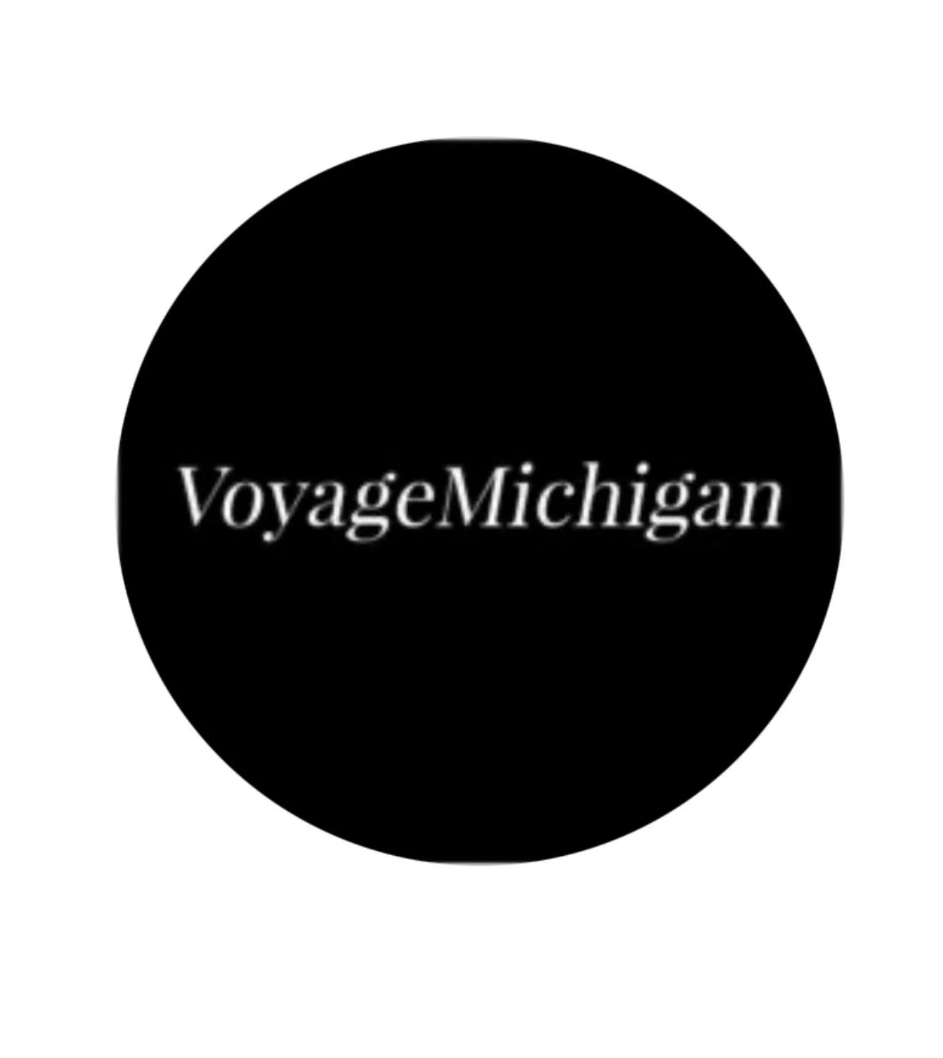Black circle with white text that reads 'VoyageMichigan'