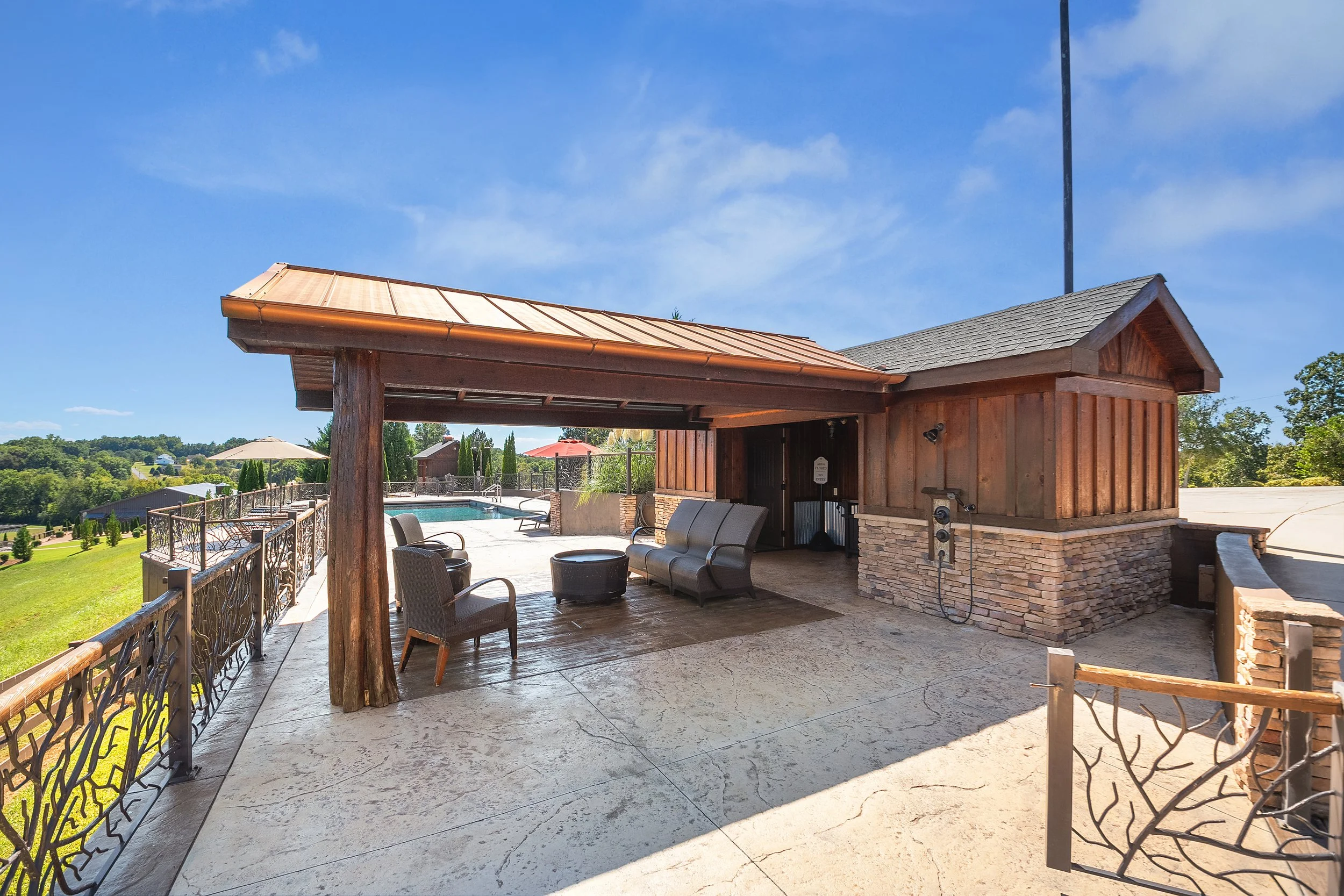 pool house with bathroom at Ocoee River Estate featuring an outdoor shower and seating area