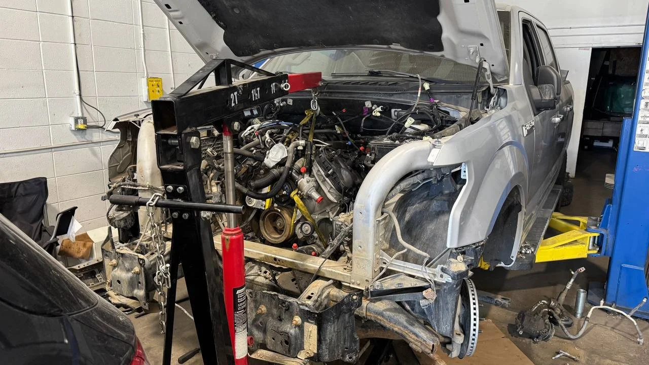 Pickup truck engine repair with an engine hoist at Spectrum Truck Services in Calgary