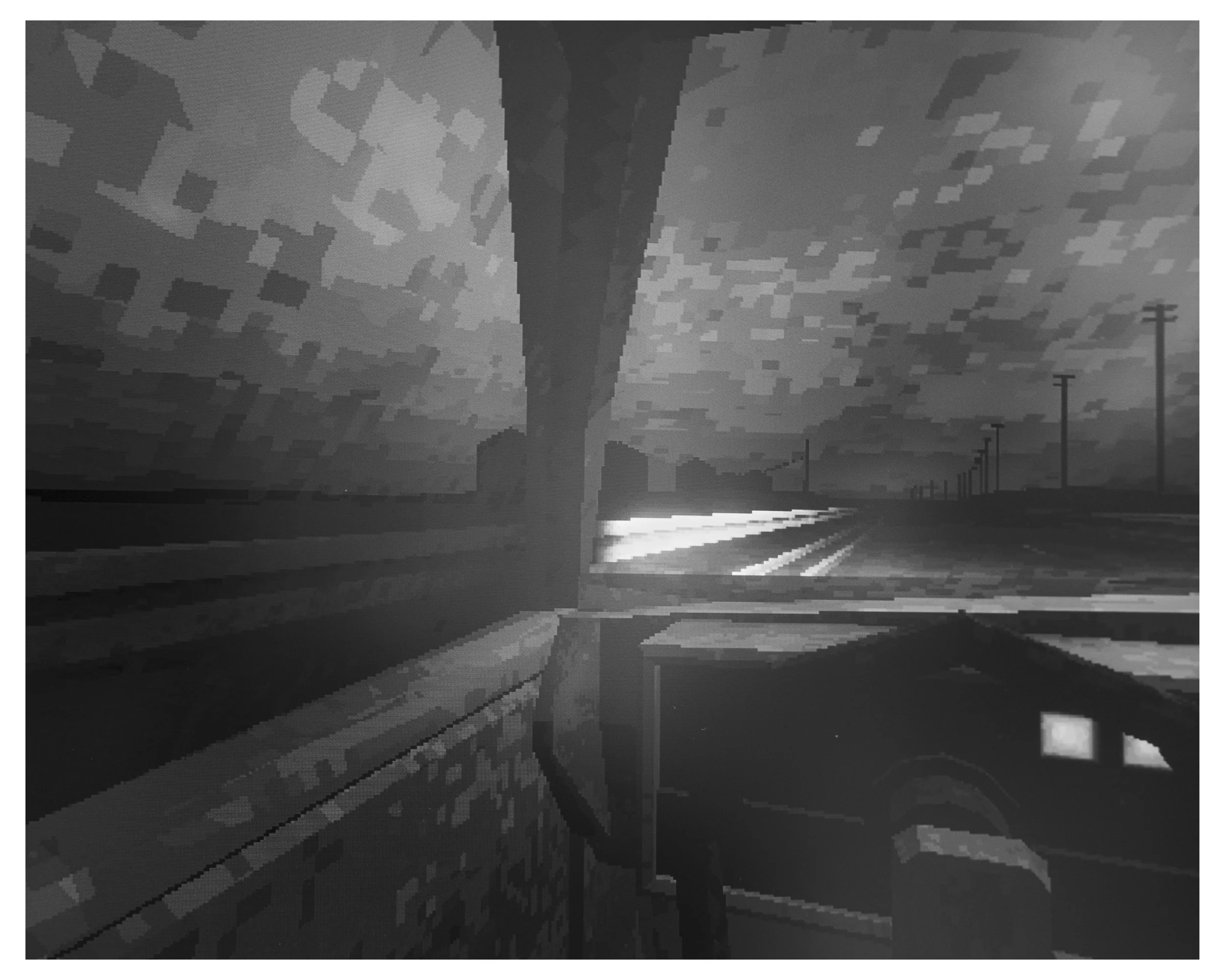 A black and white photo of a tall chimney or tower in an industrial area with railroad tracks and streetlights in the foreground.