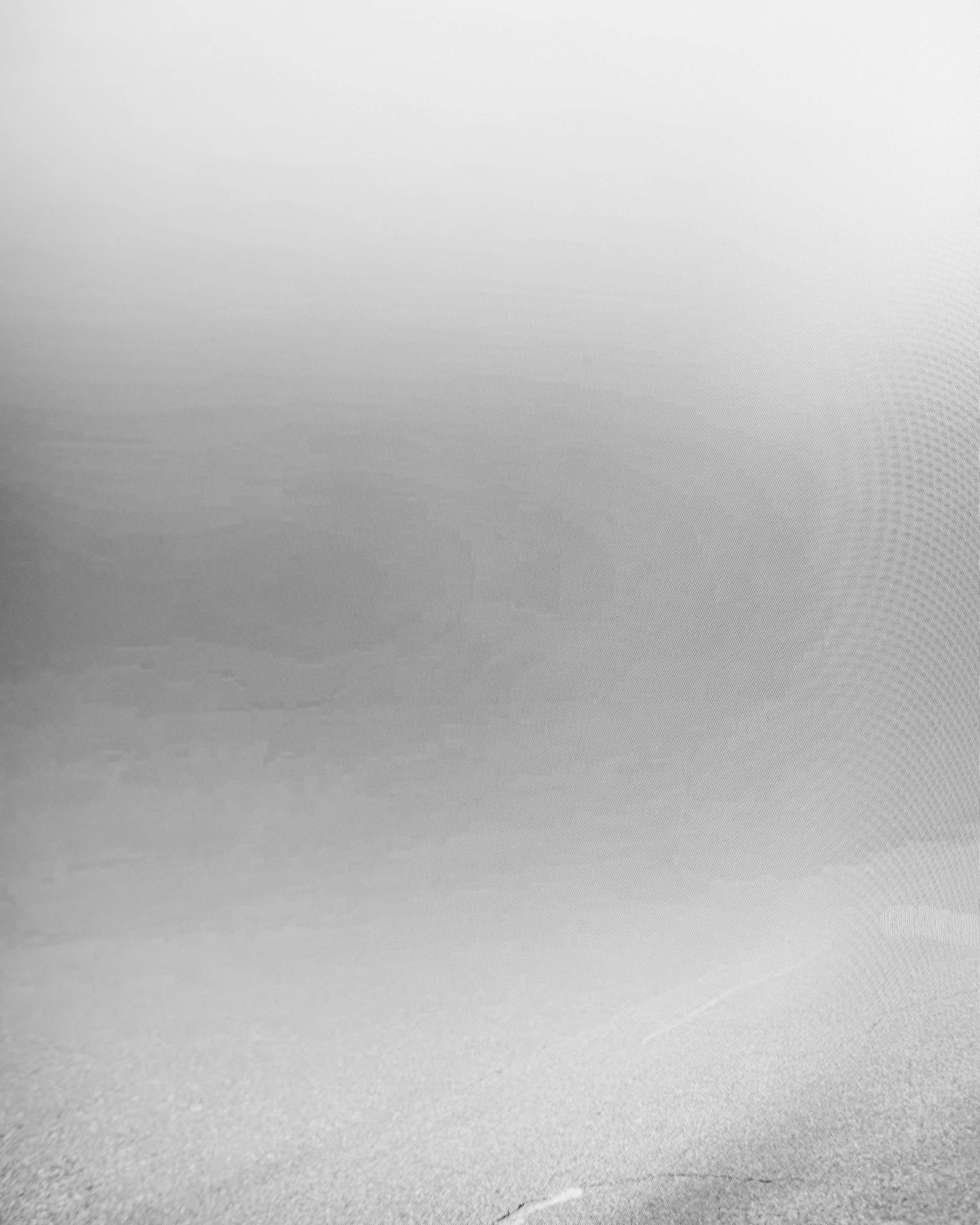 Gray textured paper with a slight gradient and faint crumples at the bottom.