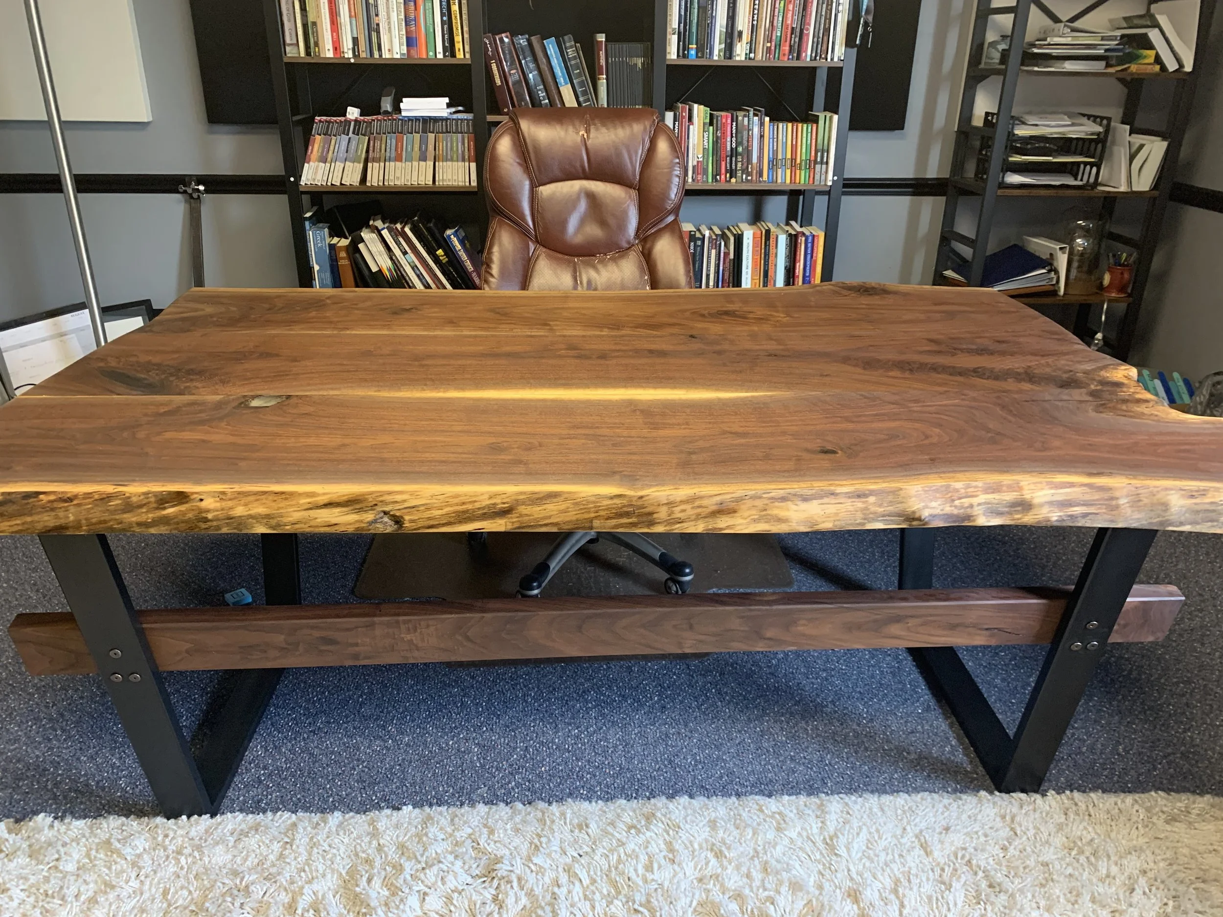 Walnut, live edge executive desk with black metal legs.