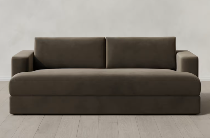 Gray sofa with clean lines against a plain white wall.