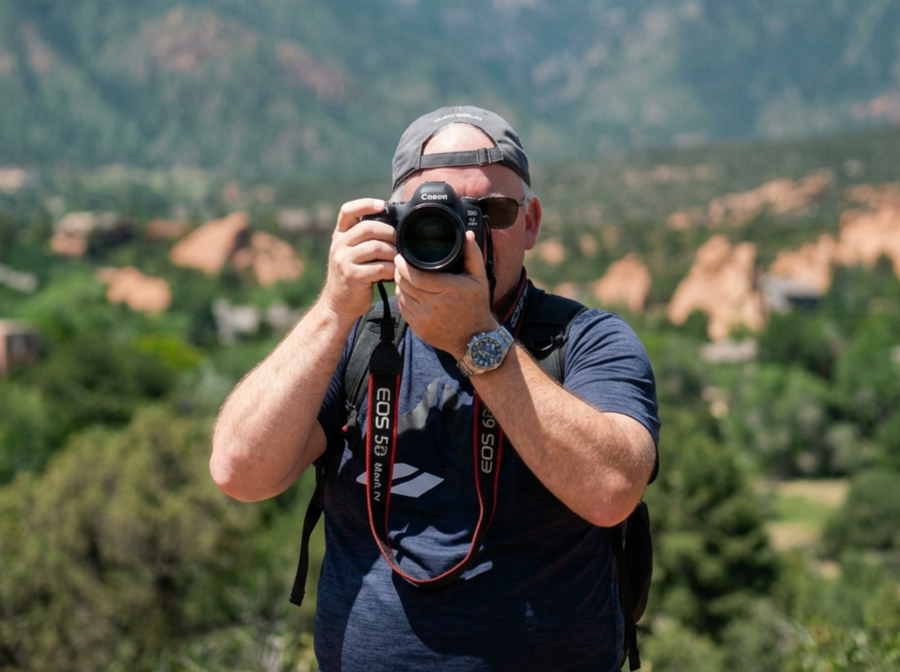 Jiri Kriz holding a Canon camera outdoors.