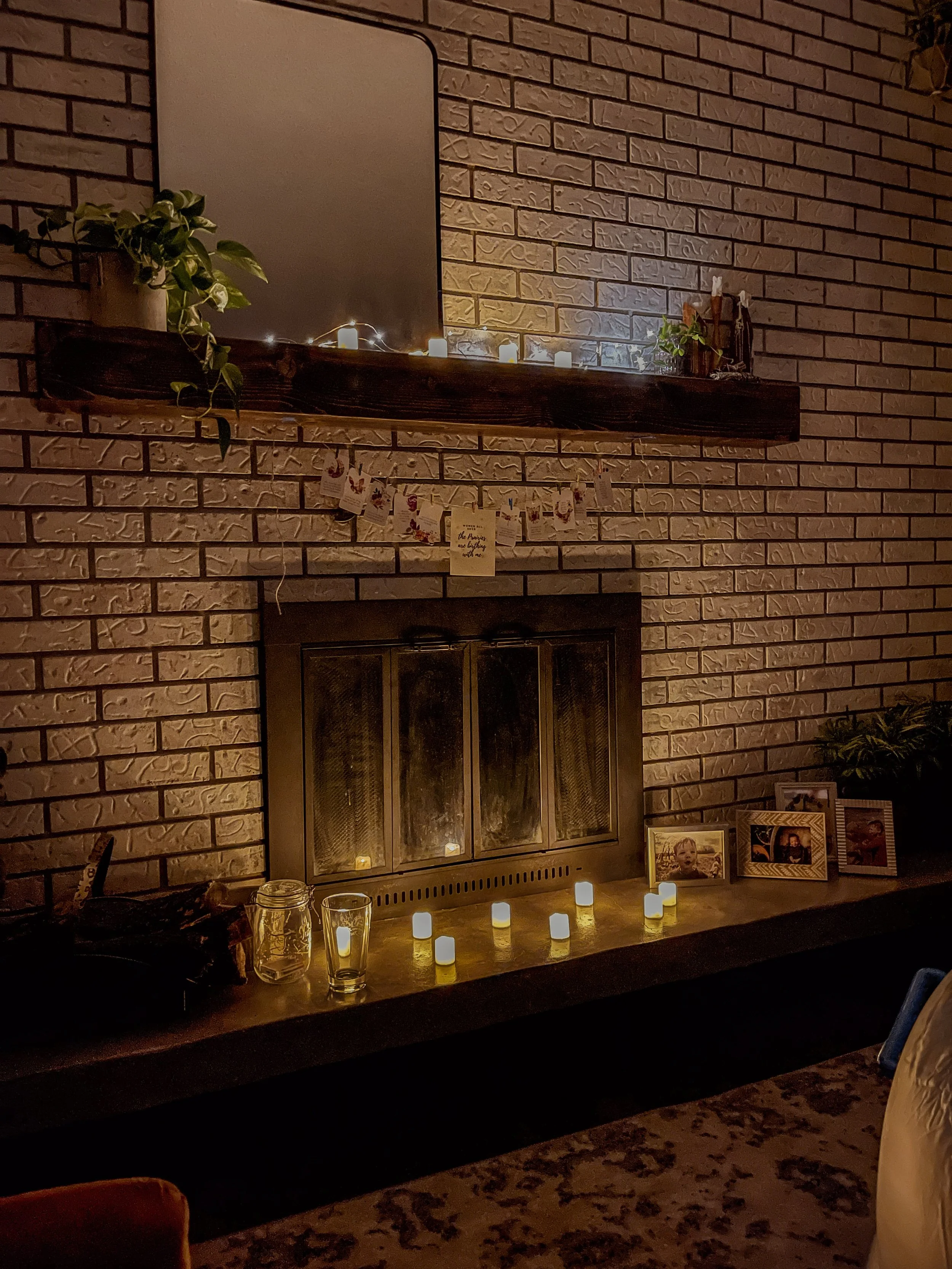 Photo of home birth set up. Candles and affirmation card hang along a fireplace