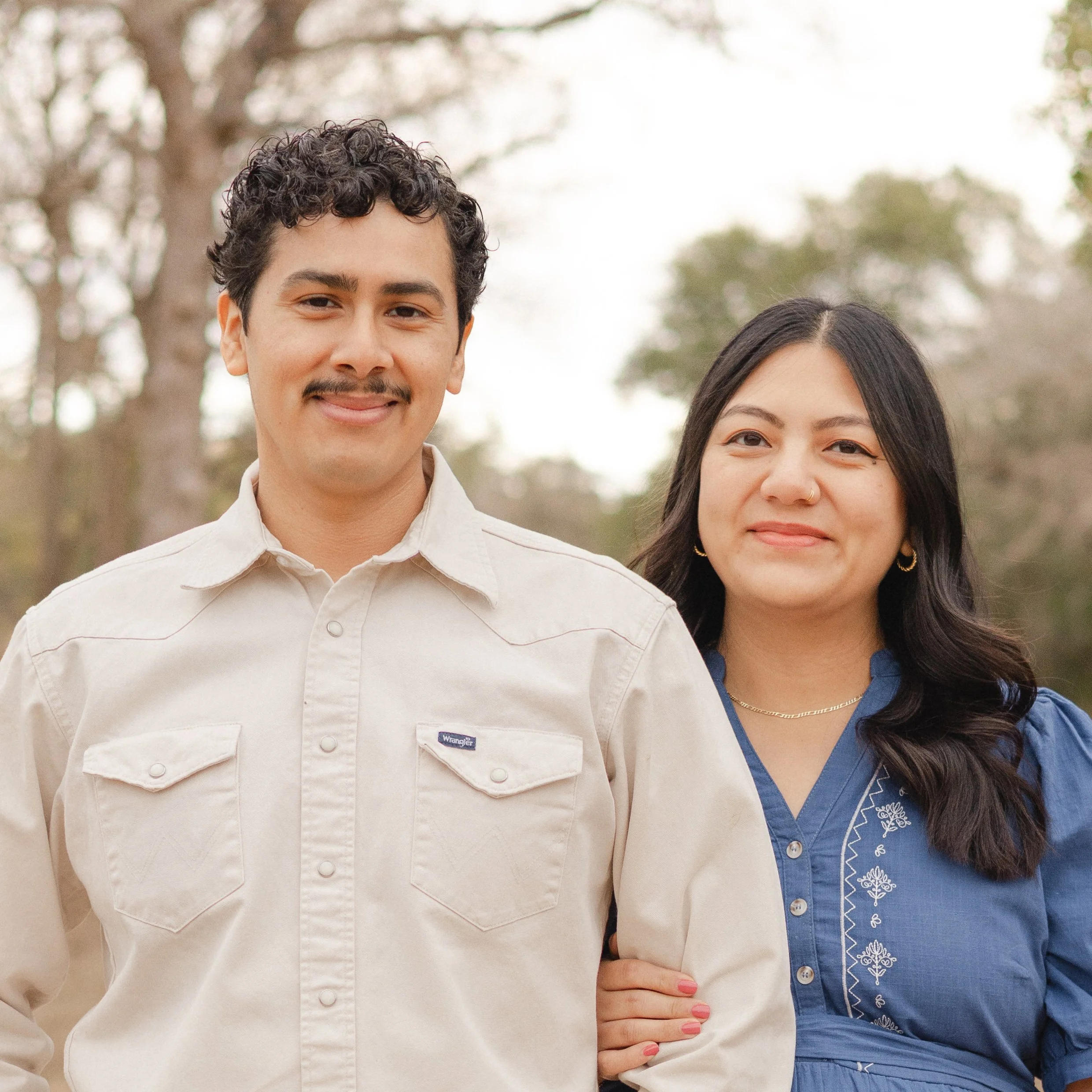 Photo of Nopalito Coffee owners Javier and Erika. Javier wears a light-colored button-up shirt, and Erika wears a blue embroidered blouse.