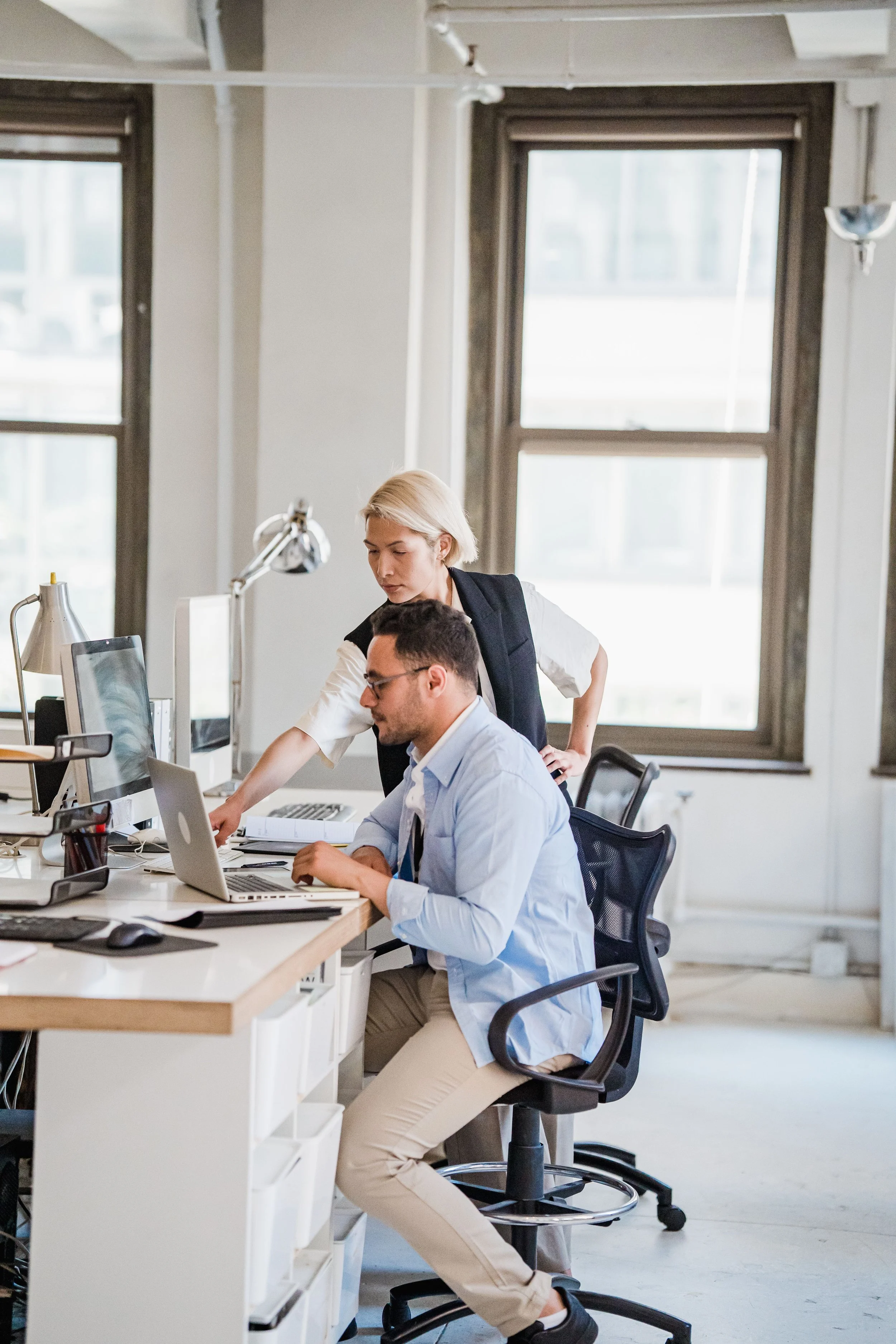 Australian business team working in a modern office, representing managed IT support, technology assistance and ongoing business IT services.