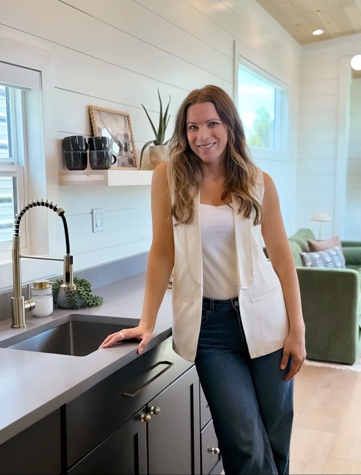 Lydia, owner and interior designer of Birch & Home, standing in a modern kitchen.