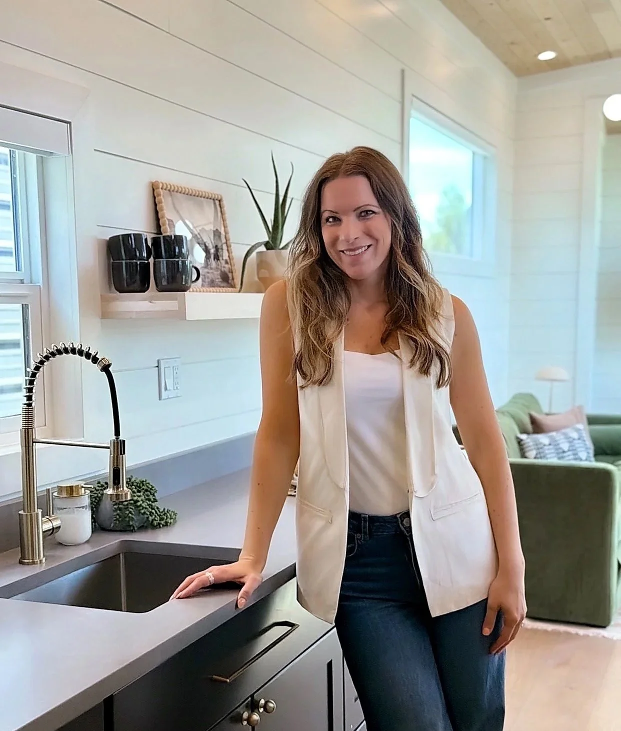 Birch & Home interior designer standing in a bright, modern kitchen.