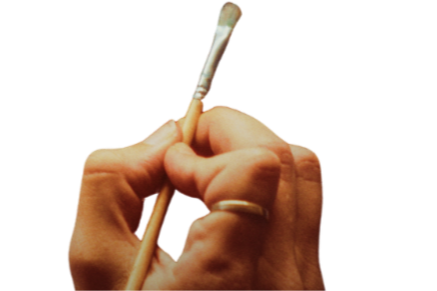 Close-up of a hand holding a small paintbrush.