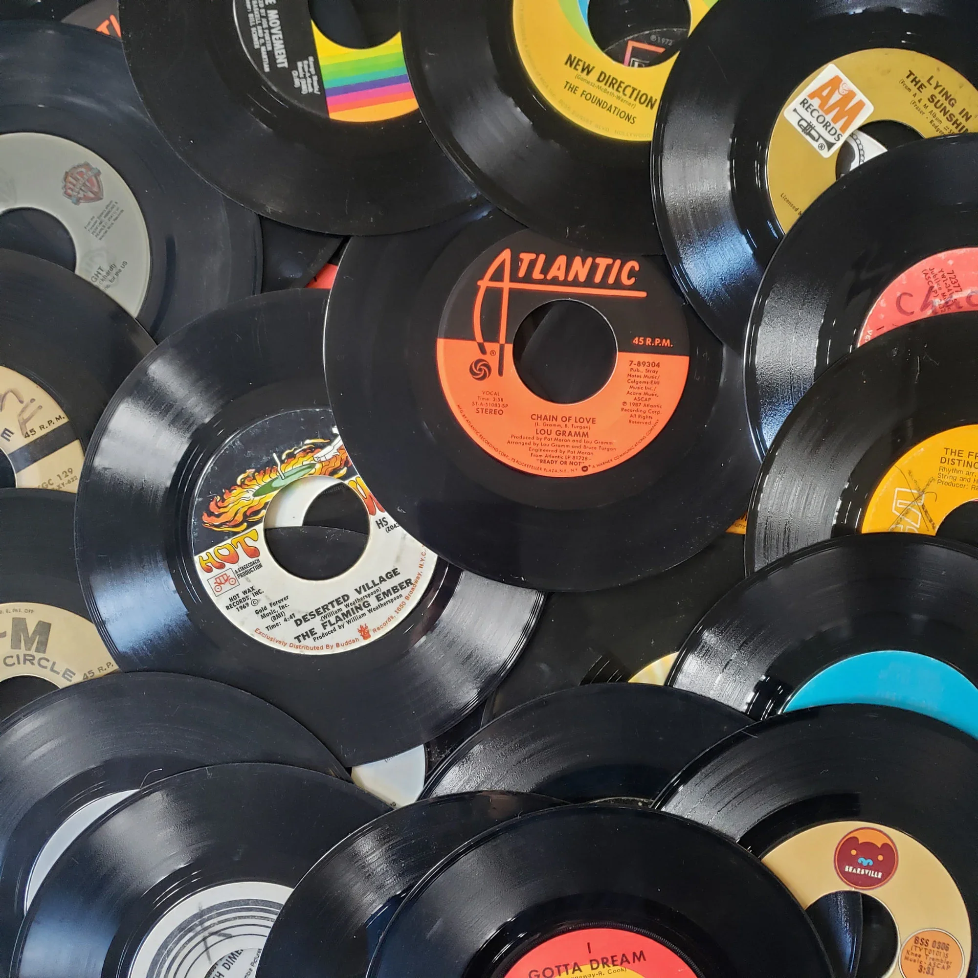 A collection of vintage vinyl records overlapping each other, displaying various label colors and titles.