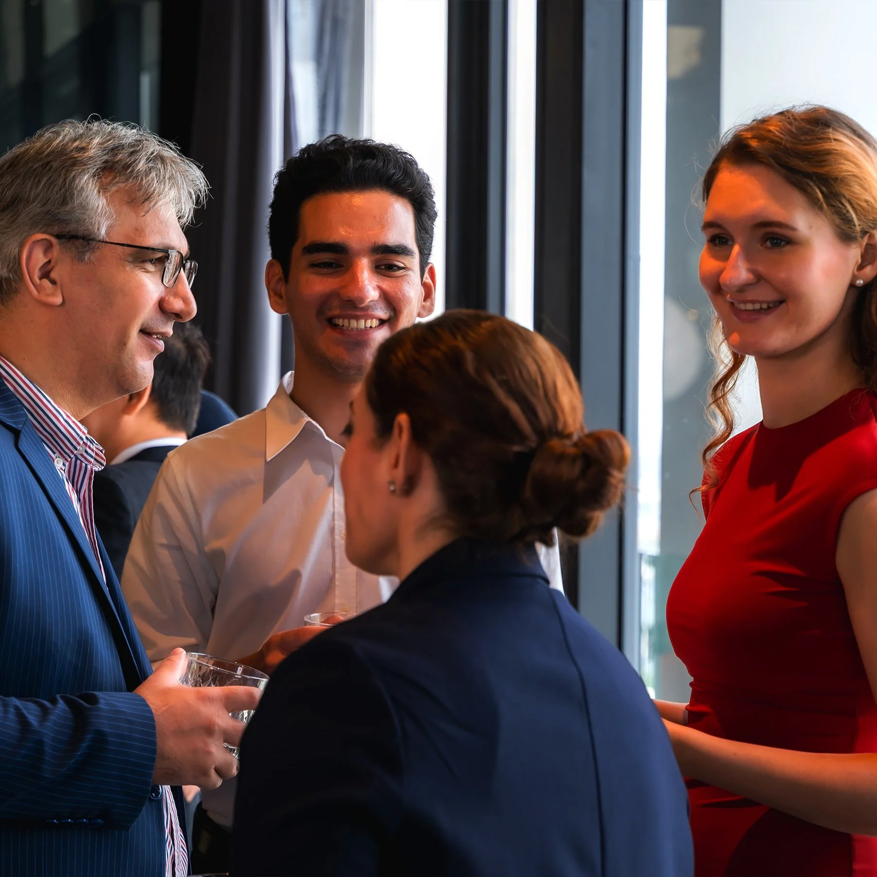 Professionals chatting and smiling at a business networking event