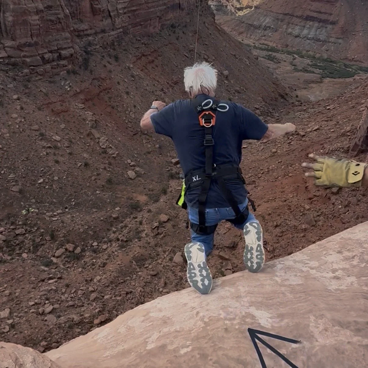 Larry at 70 years old jumping off a cliff with Moab Swingers