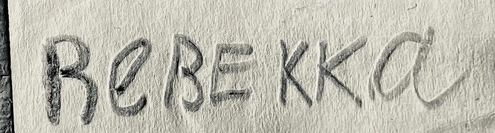 Handwritten pencil text reading “B5B-KK” on textured paper