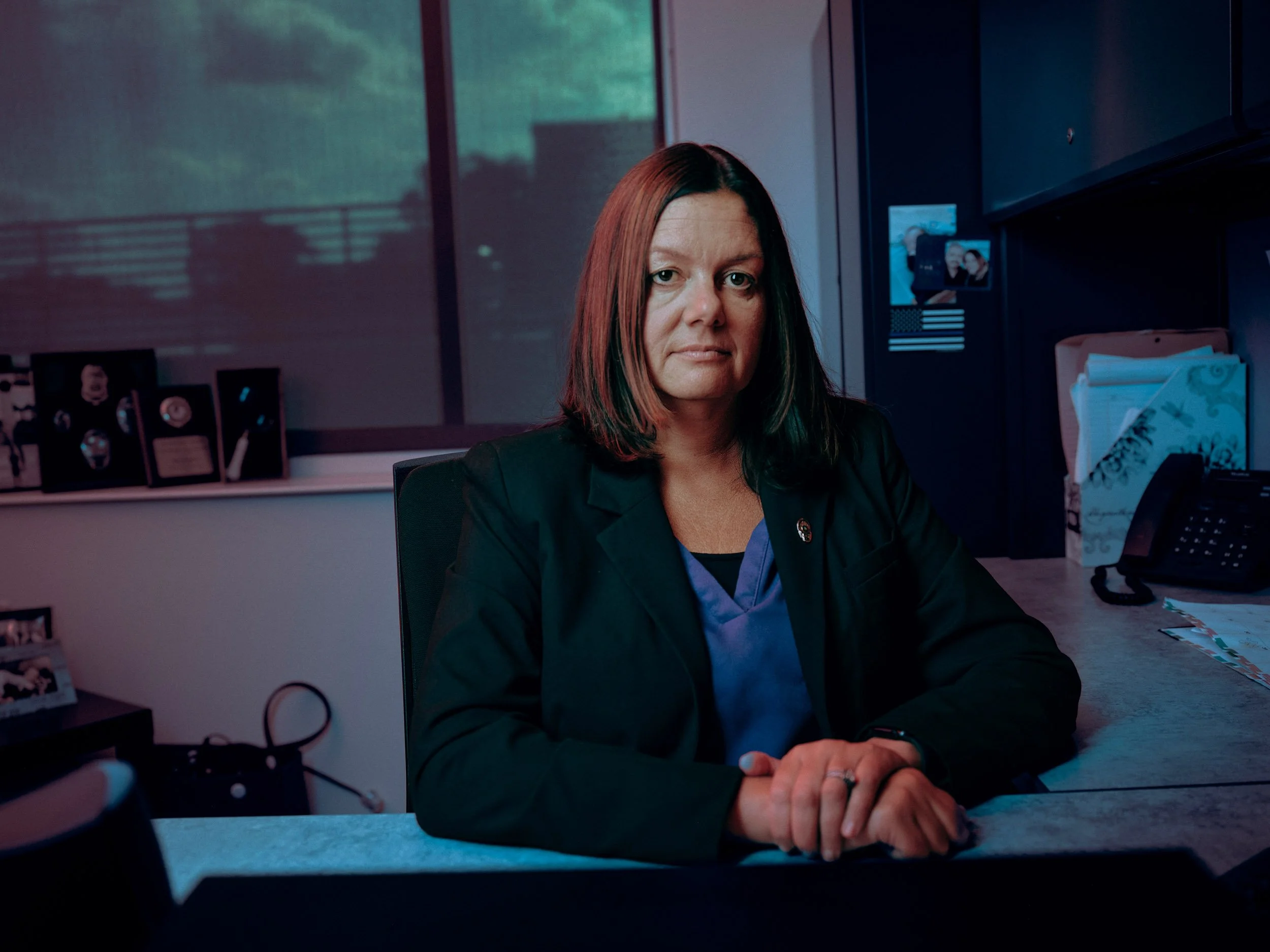 Woman in a blazer sitting at a desk in an office Detective for Wall Street Journal