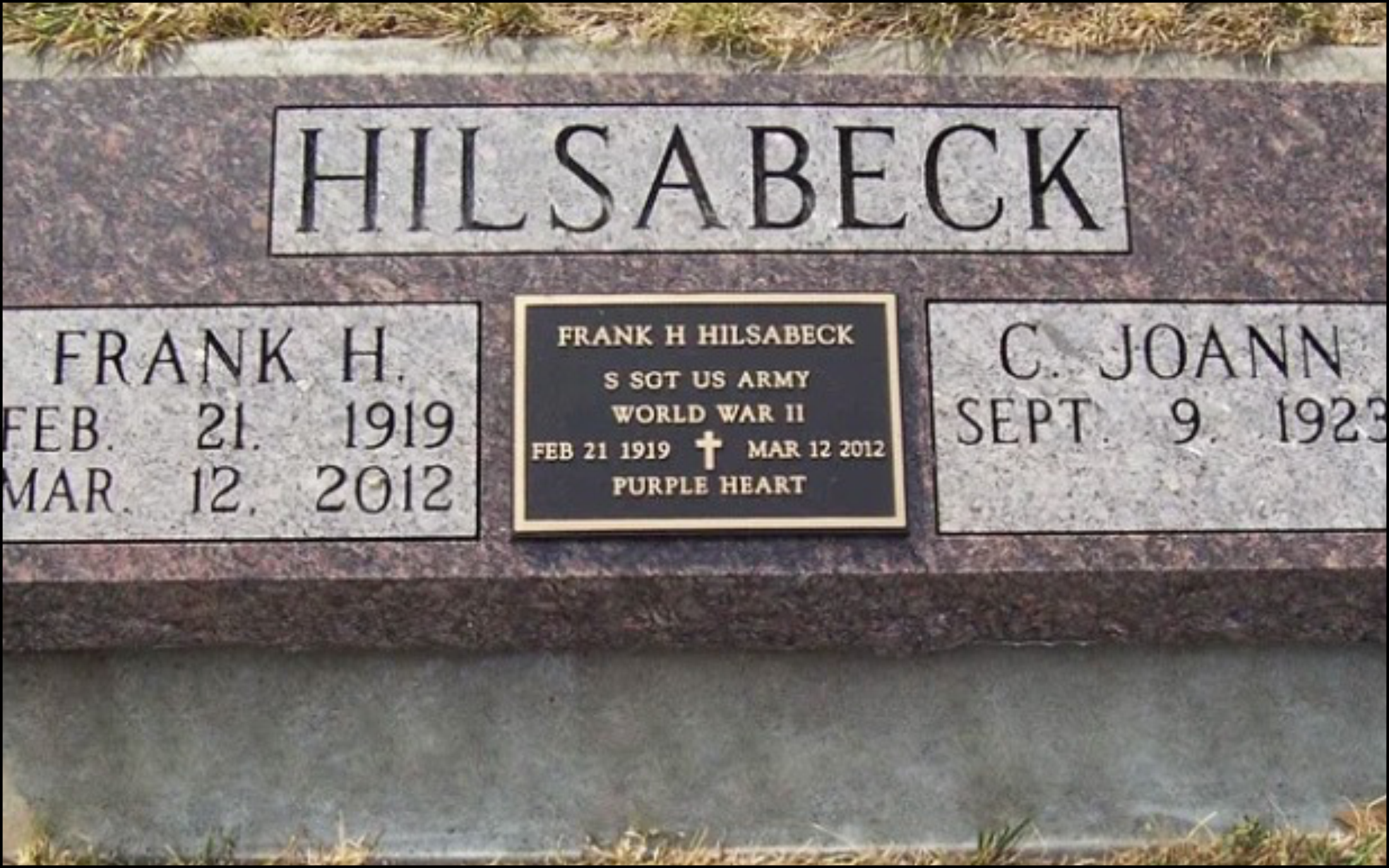 Gravestone with the name Hilsabeck, two additional plaques honoring Frank H. Hilsabeck and C. Joann, noting military service and dates of birth and death.