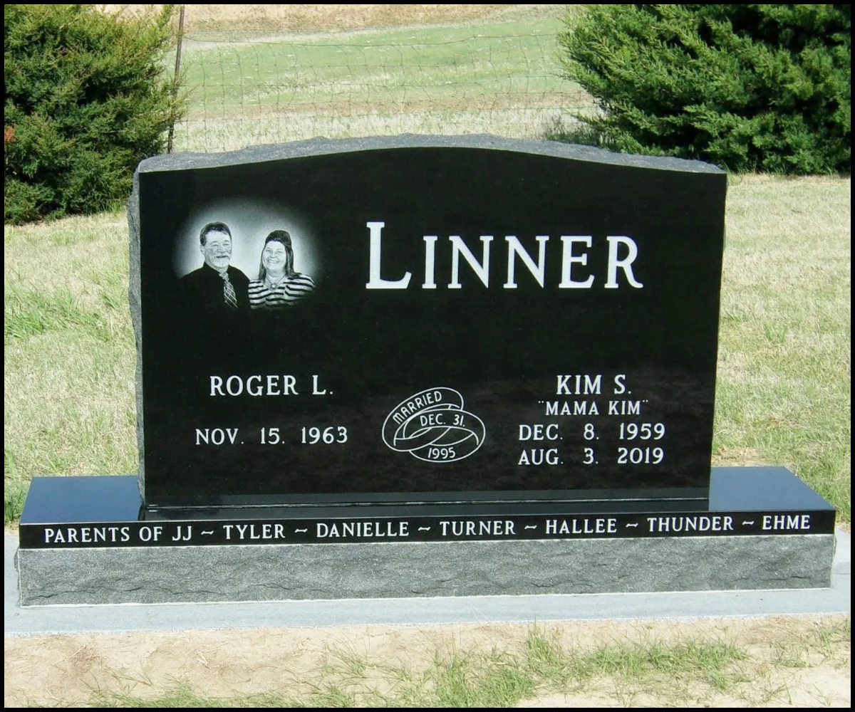 A black granite headstone for Roger L. Linner and Kim S. "Mama Kim" Linner in a cemetery. The headstone features a photo of an older man and a woman smiling. The inscription includes birth and death dates for Kim, and birth date for Roger, with a note about their marriage on December 31, 1995. The base of the headstone lists the names of several family members and their relationships.