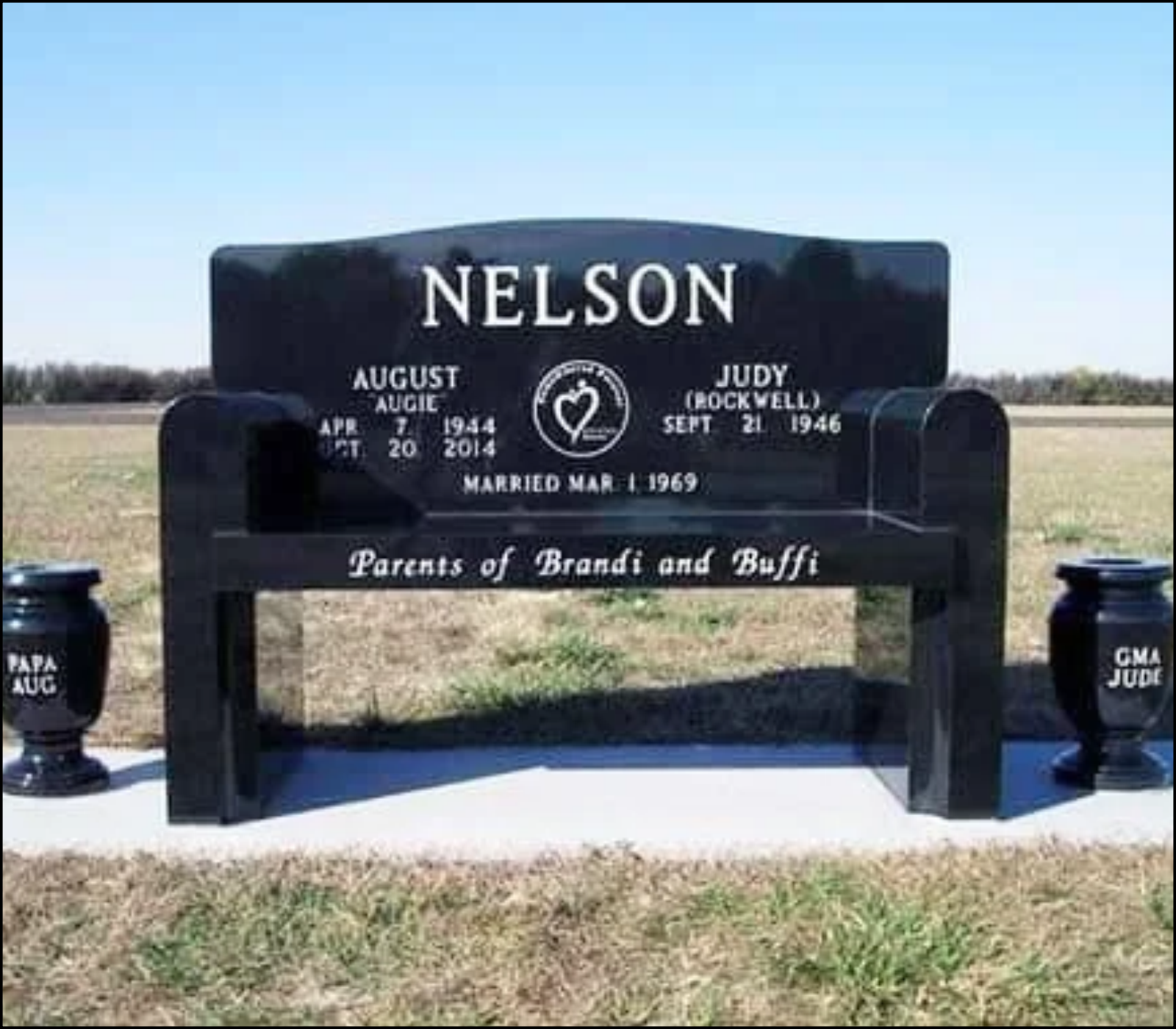Black granite headstone with the name Nelson and details of August 7, 1944 - April 20, 2014, Judy (Rockwell) September 21, 1946, married March 1, 1969, surrounded by a small fence on a grassy area.