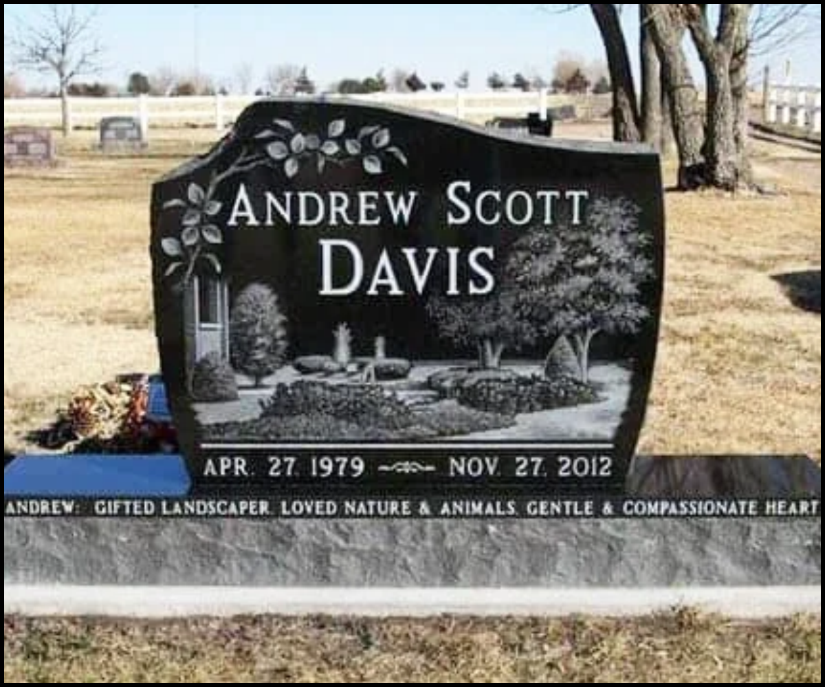 Gravestone for Andrew Scott Davis with engravings of trees, flowers, and garden elements, and inscriptions with birth and death dates, located in a grassy cemetery.