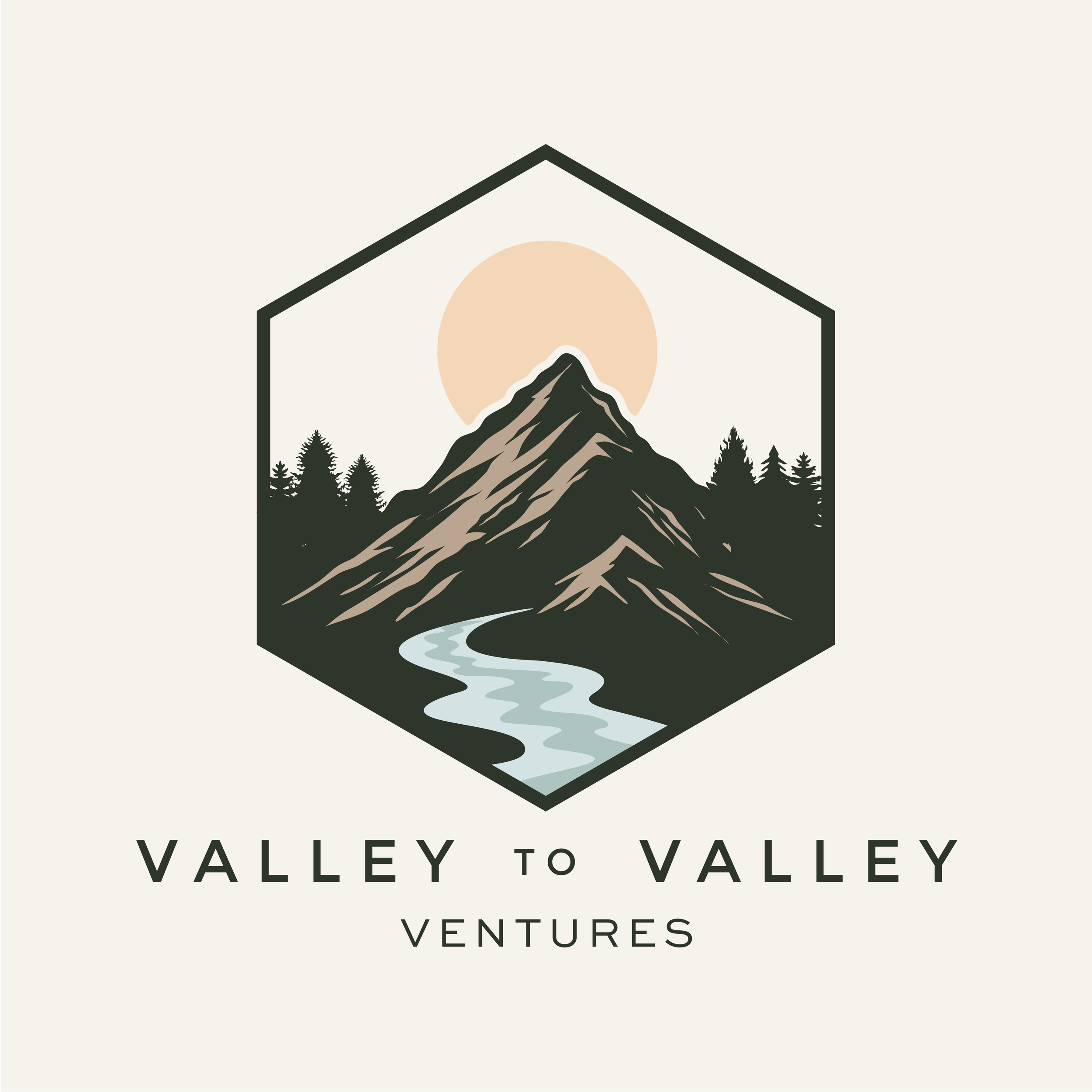 Logo of a mountain with a river flowing in front, trees on both sides, and the sun behind the mountain, framed in a hexagon, with the text "Valley to Valley Ventures" below.