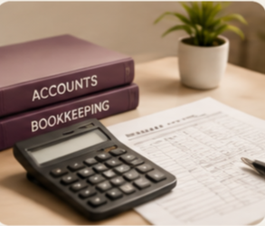 Stack of accounting and bookkeeping books, a calculator, printed financial documents, and a potted plant on a desk.