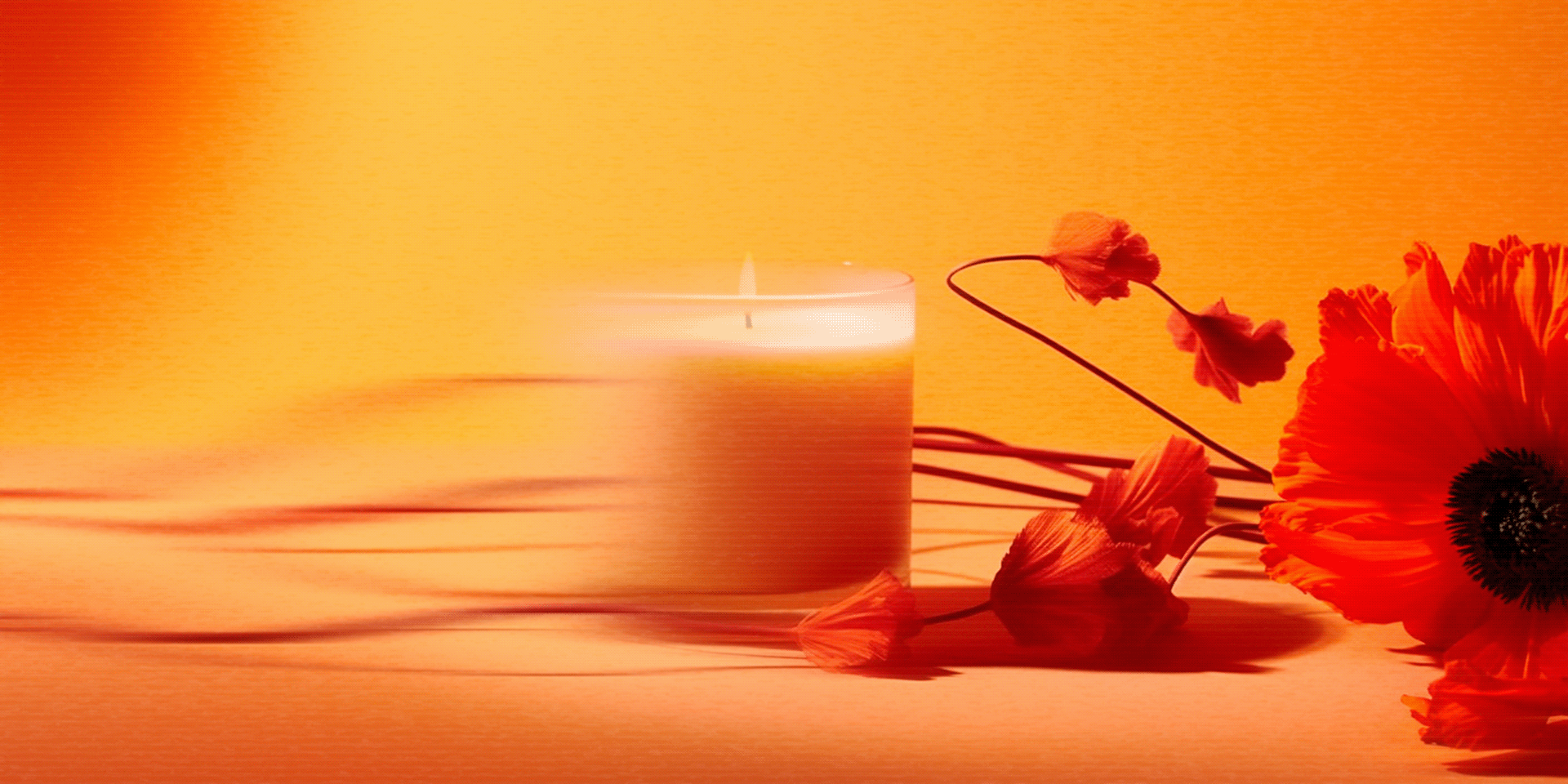 A lit candle, orange flowers, and a yellow background creating a warm, soothing atmosphere.