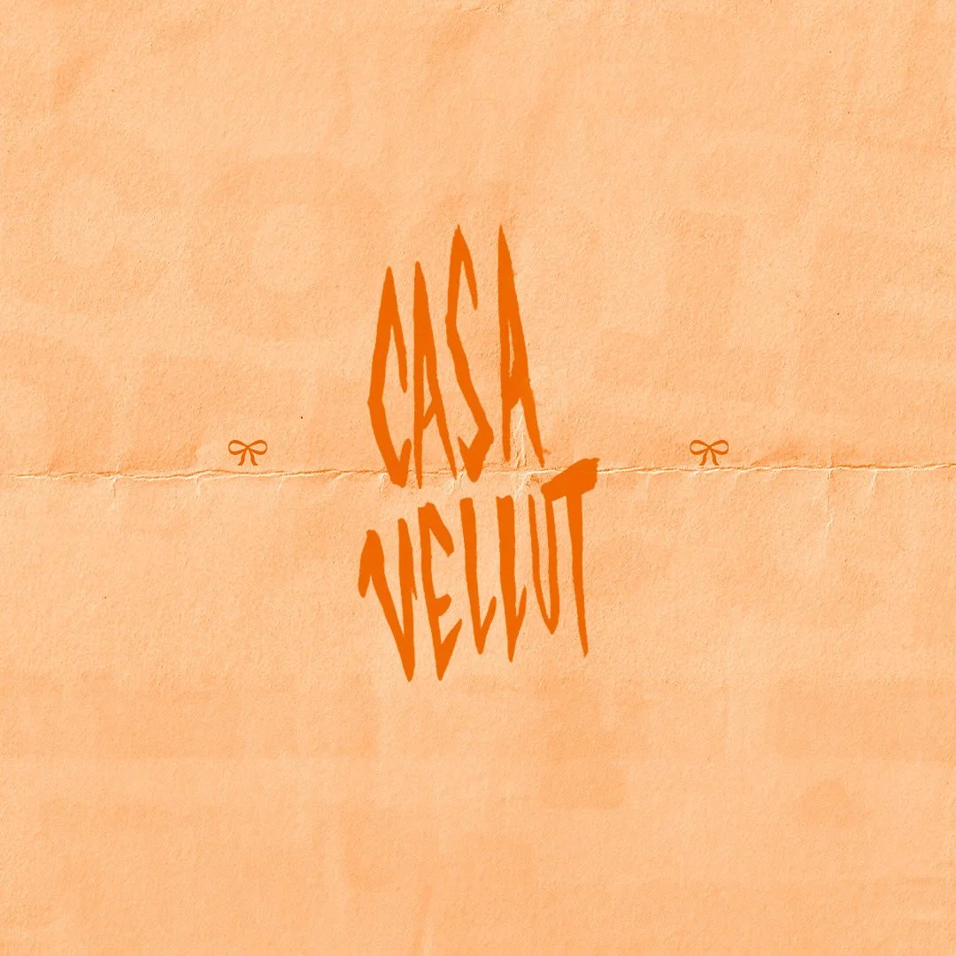 Text that reads 'CASKA VELVET' in orange, stylized font on a peach-colored background.