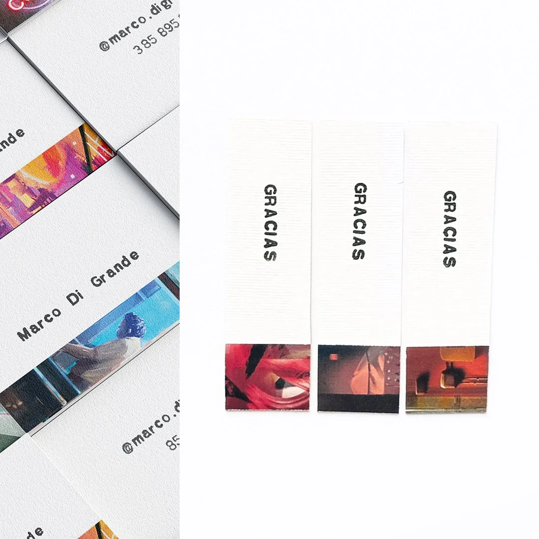 Three separate white paper bookmarks with black text reading 'GRACIAS' and small colorful images at the bottom.
