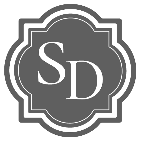 A logo with the initials 'SD' inside a decorative border.