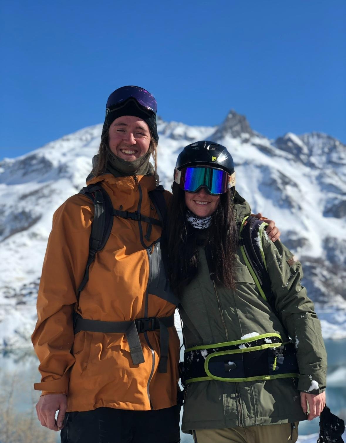 Frank & Joe on the mountain in Tignes, wearing ski/snowboard gear and smiling