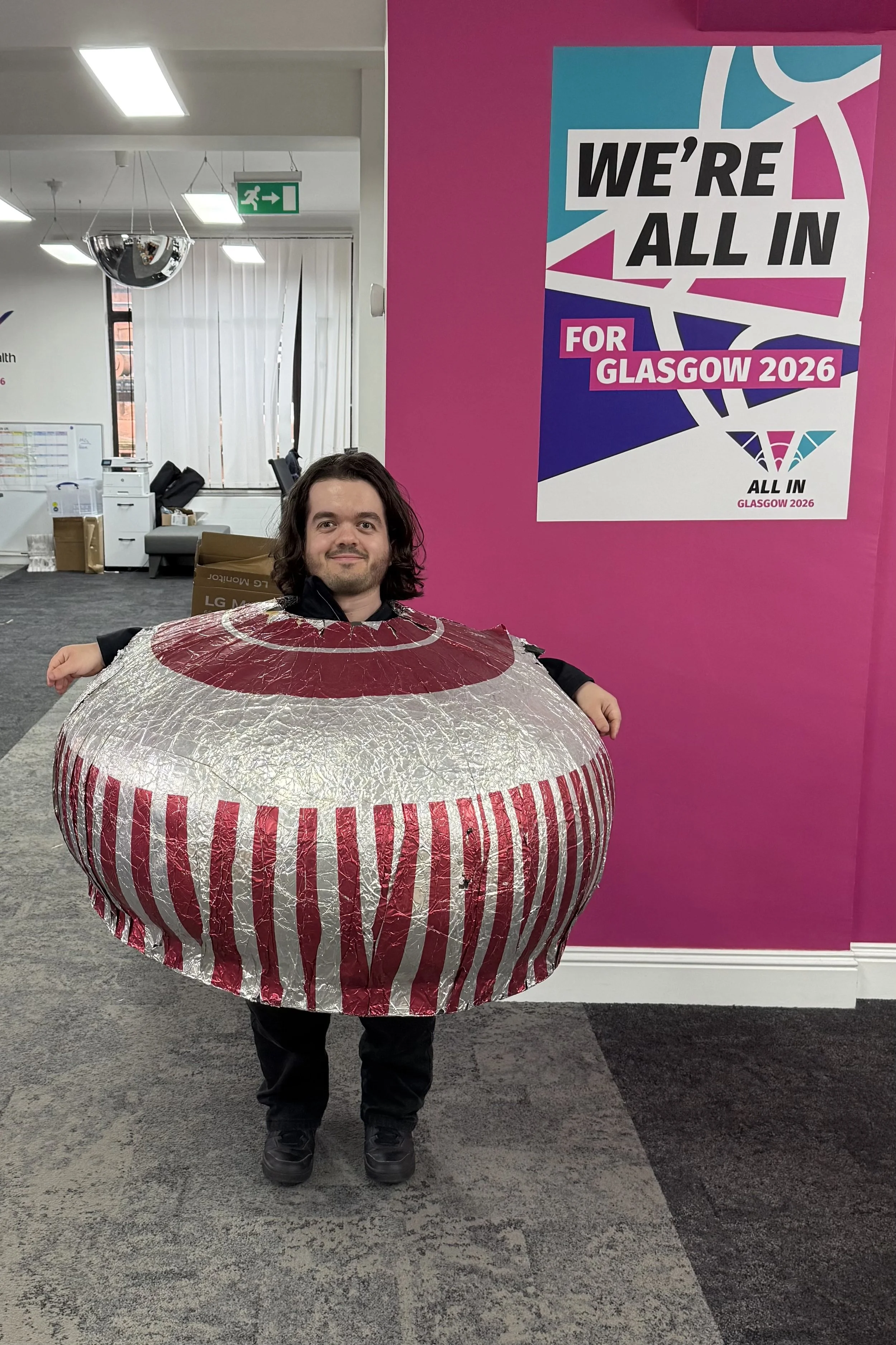 Dwarf man wearing a cardboard Tunnocks Teacake costume