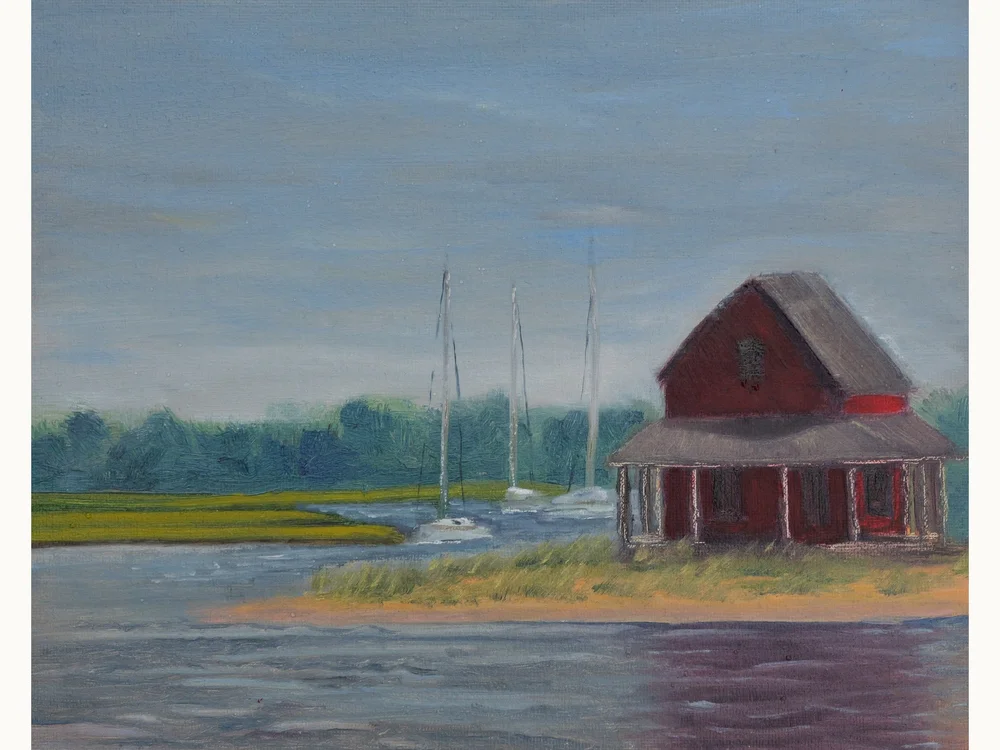 A red shack on a grassy island at Guilford marina, sailboat masts behind it.