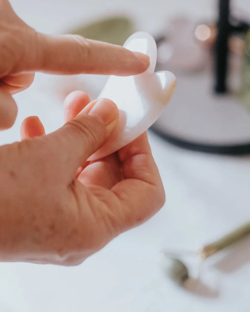Soin du visage avec une pierre de gua sha.