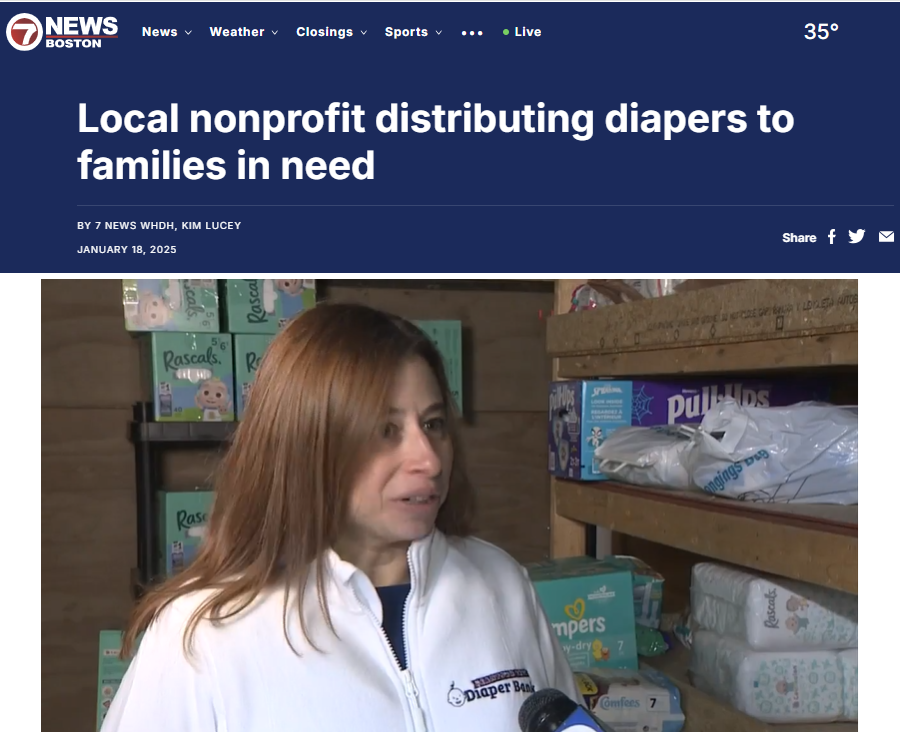 A woman being interviewed in a storage room with shelves filled with diapers and baby products.
