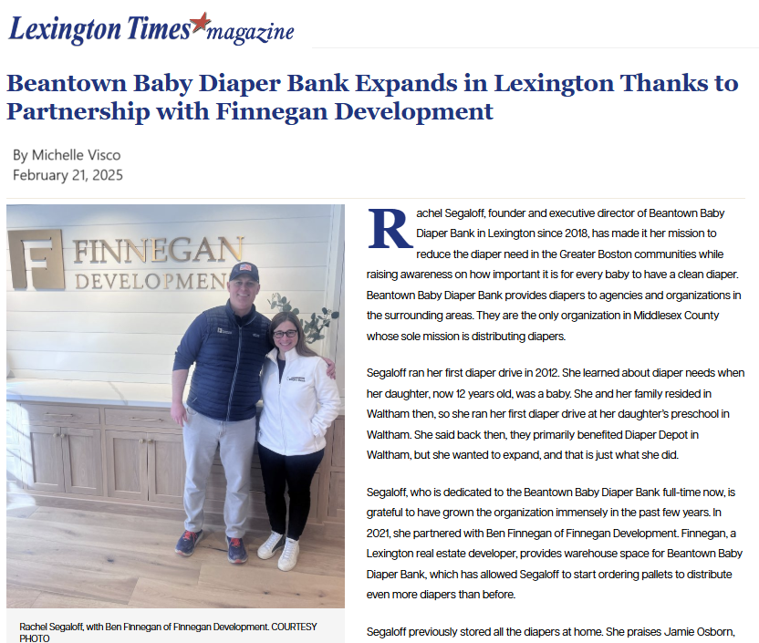 Photo of Rachel Segaloft standing with Ben Finnegan at Beantown Baby Diaper Bank, in front of a wall with the organization’s logo.