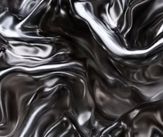 Close-up of shiny black, silky fabric with folds and wrinkles.