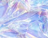 Close-up of iridescent, crumpled plastic or cellophane material with rainbow sheen.