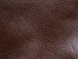 Close-up of brown textured leather surface.