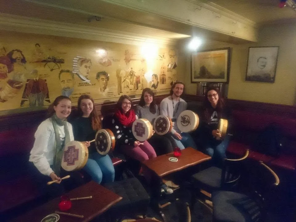 people enjoying learning to play bodhrán