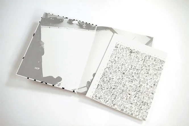Interior spread displaying print publication alongside intricate, full-bleed linework insert.