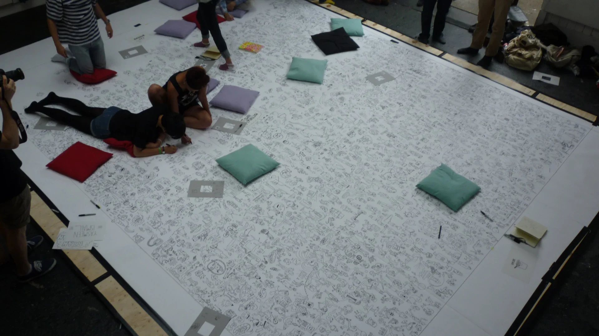 Overhead view of the large-scale floor installation, featuring an interactive visual space for viewers.