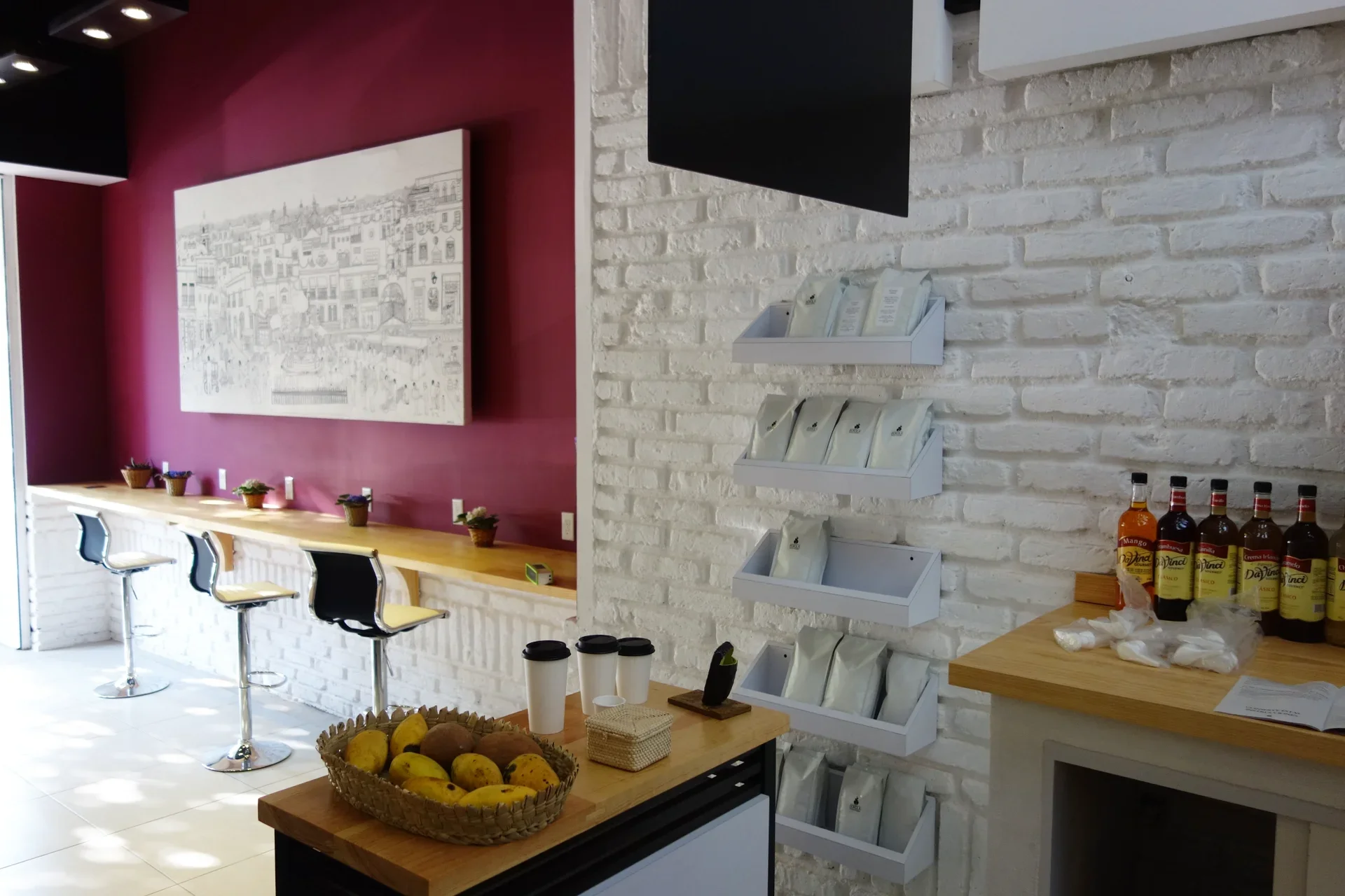 Perspective view of the cafe interior showing the installed artwork in relation to the counter space.