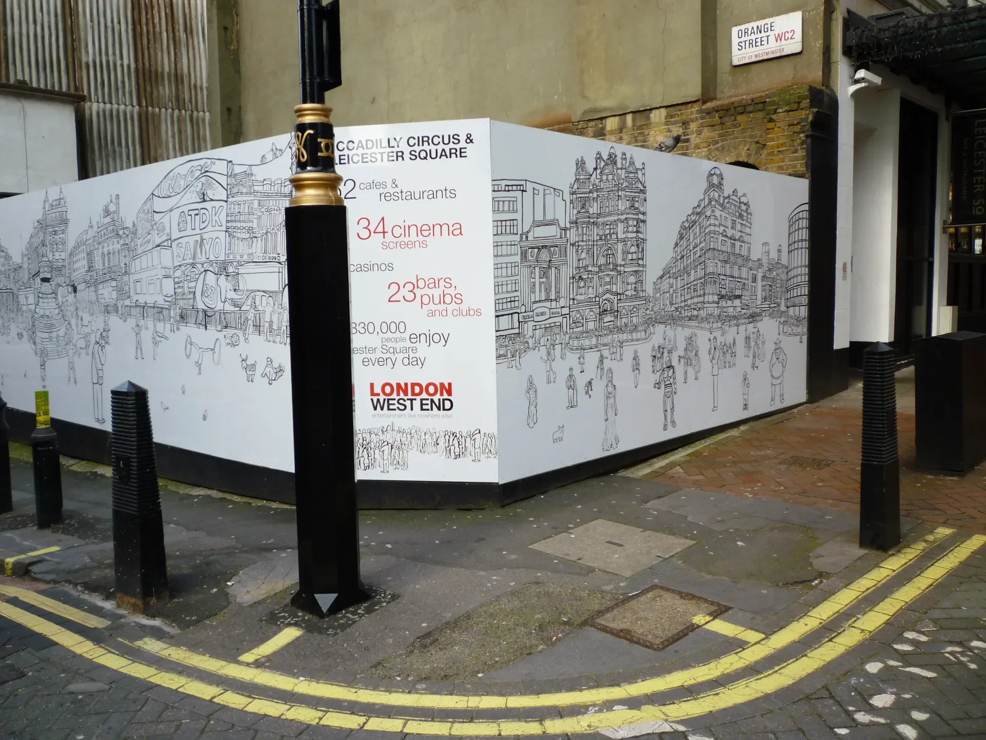 Corner perspective showing the custom artwork hoarding wrapping around Orange Street and St Martin's Street.